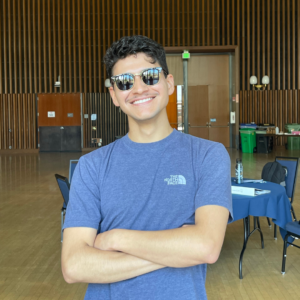 Christian smiling wearing his signature sunglasses